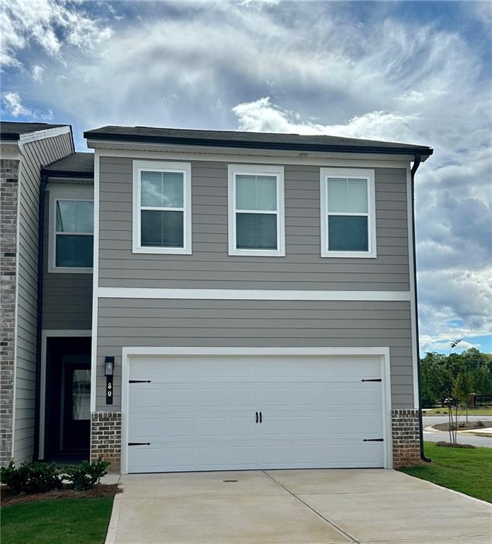 a front view of a house with a garage