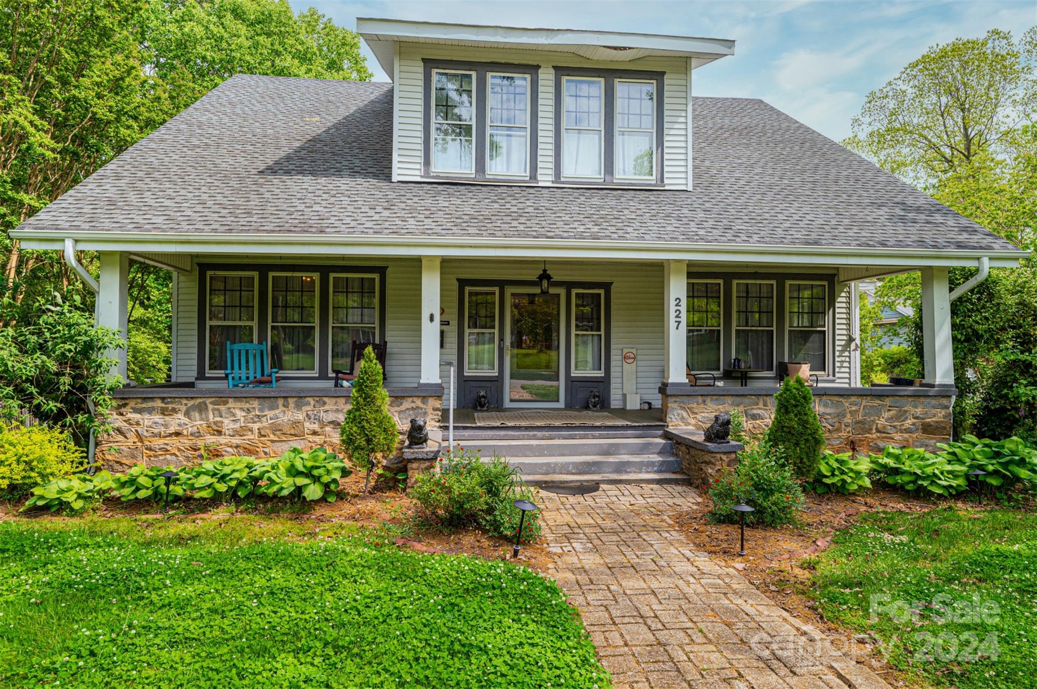 a front view of a house with garden and porch