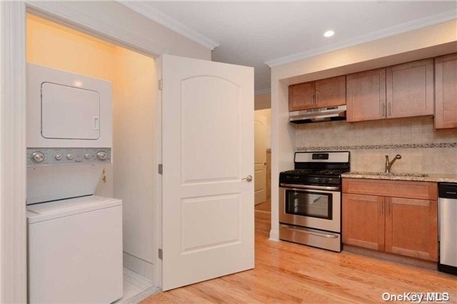 a kitchen with stainless steel appliances granite countertop a refrigerator stove and sink