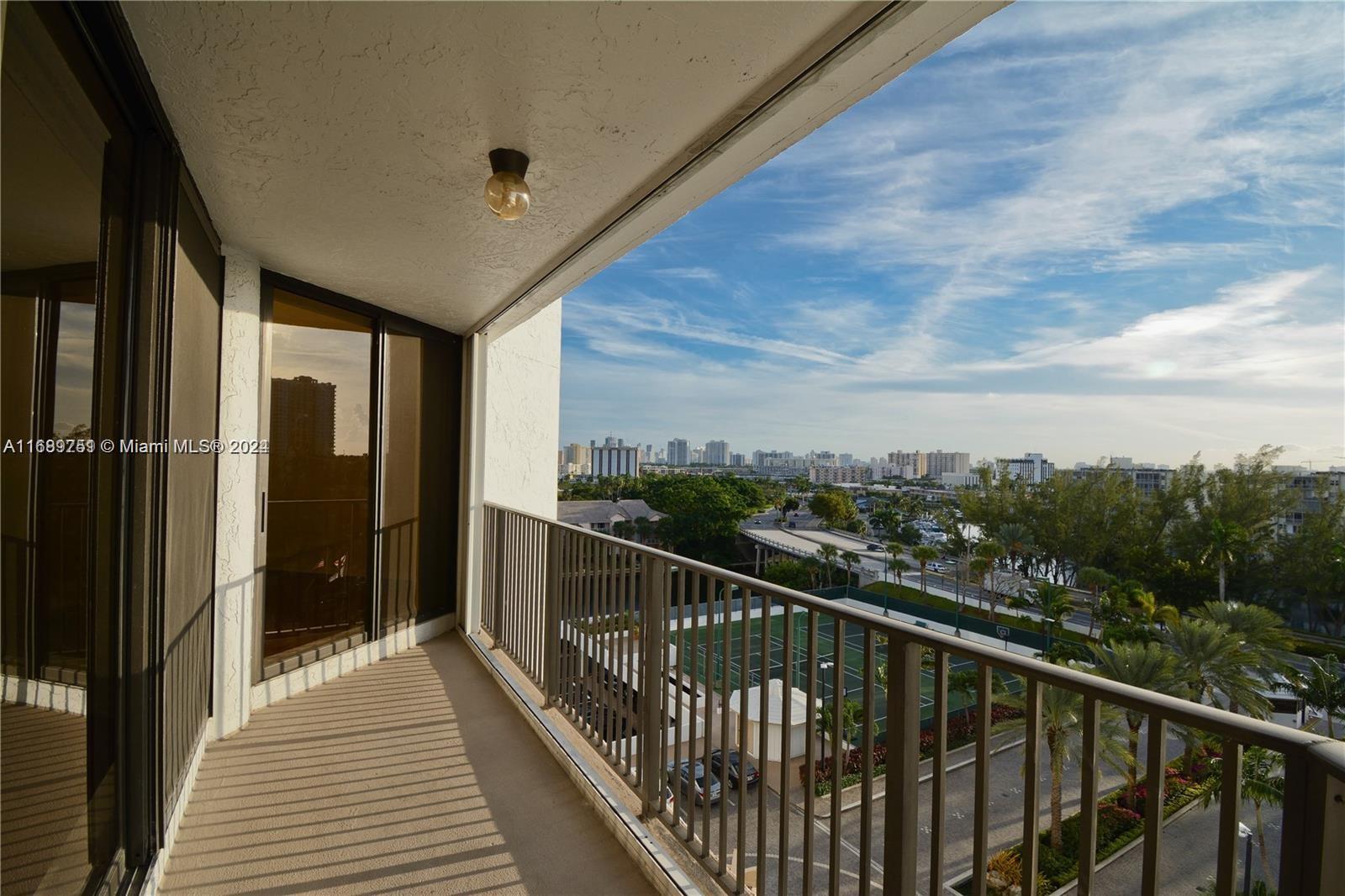 a view of a balcony with wooden floor