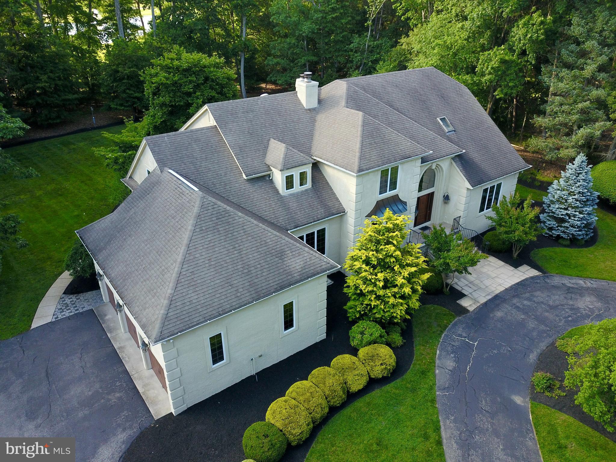 a aerial view of a house with a yard and a sitting area