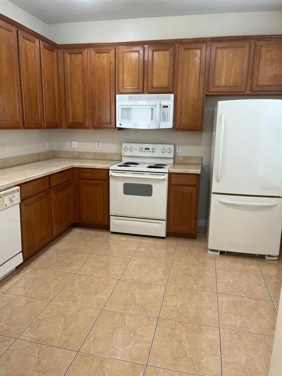 a kitchen with a cabinets and white appliances