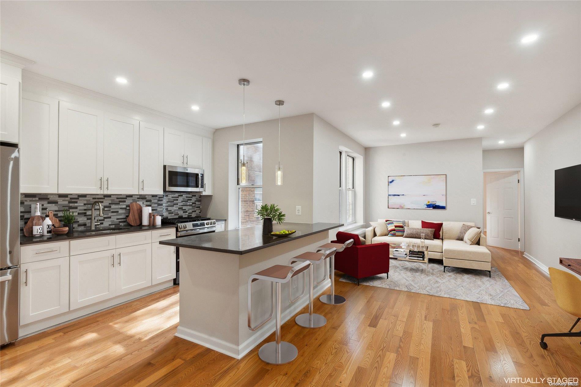 a kitchen with stainless steel appliances kitchen island granite countertop a sink and cabinets