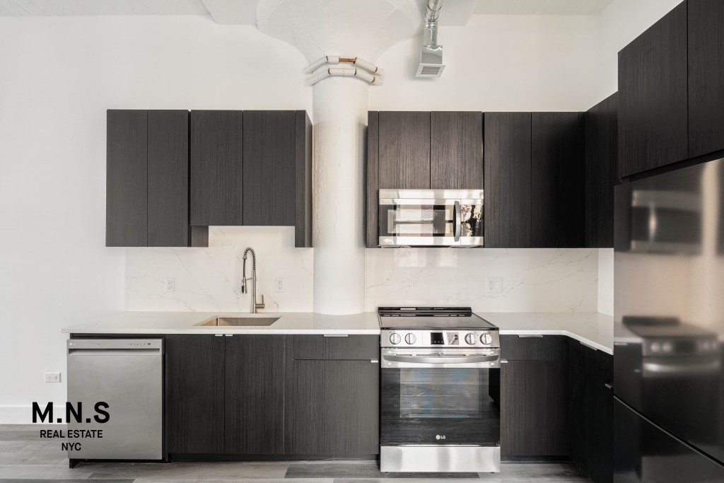 a kitchen with stainless steel appliances a sink stove and microwave