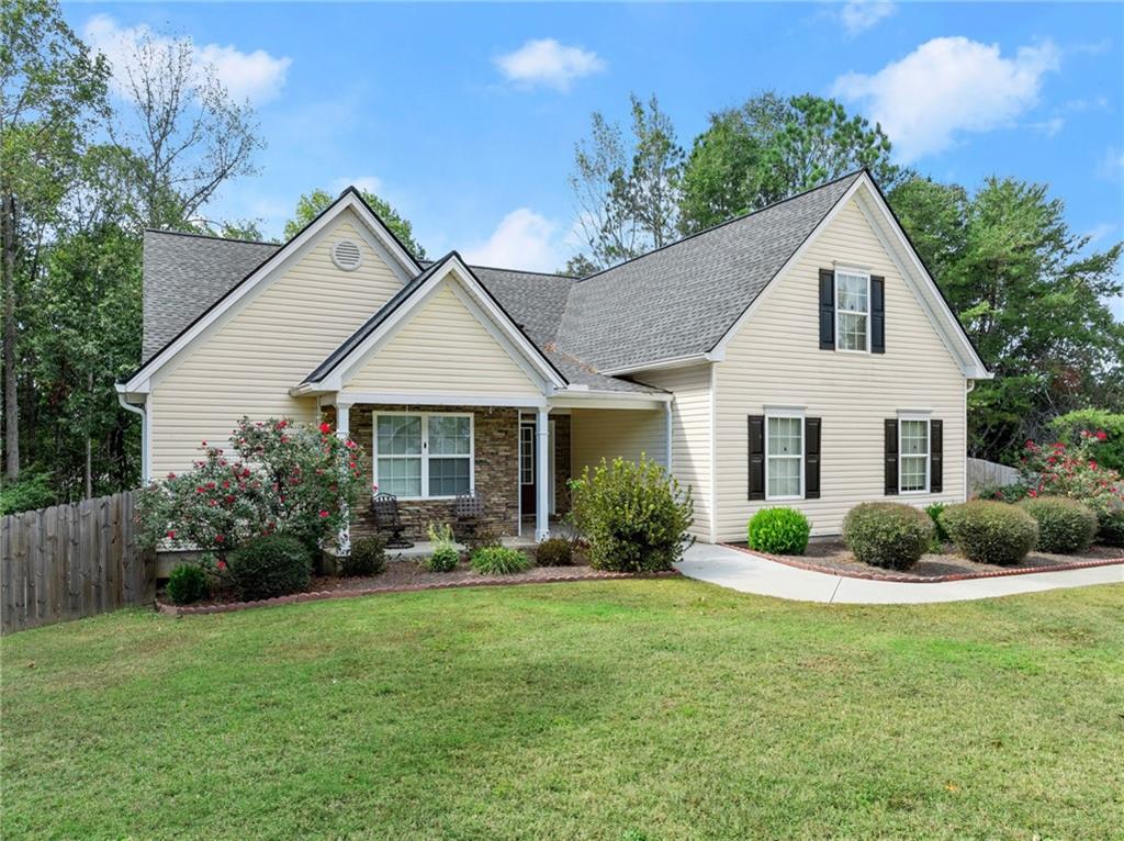 a front view of a house with garden