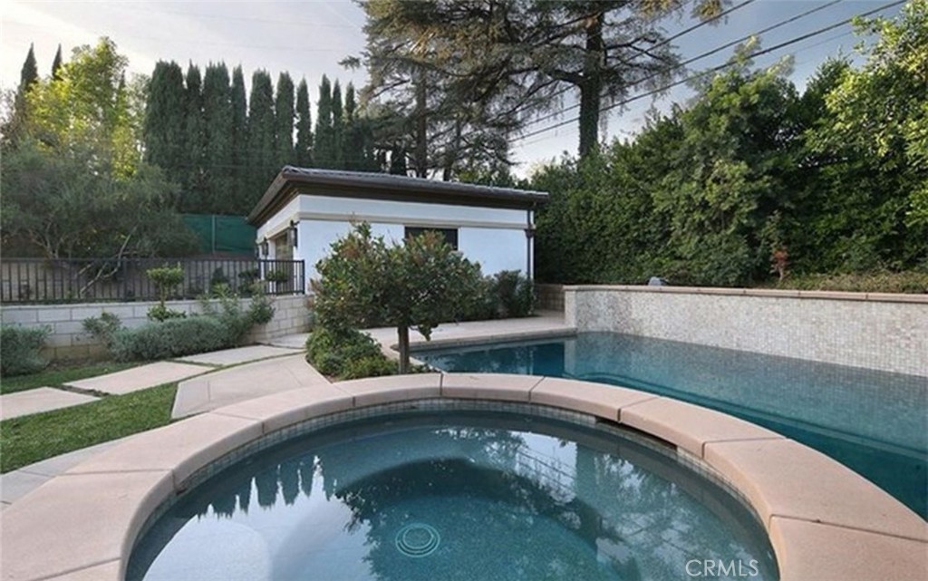 a backyard of a house with yard table and chairs