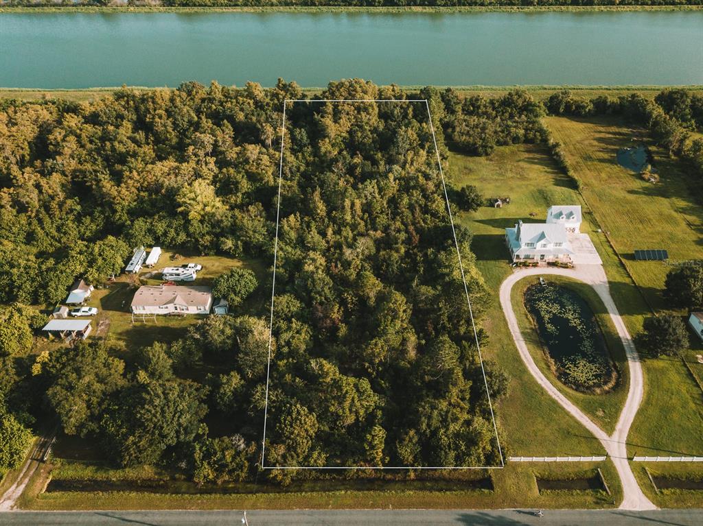 an aerial view of a house with a lake view