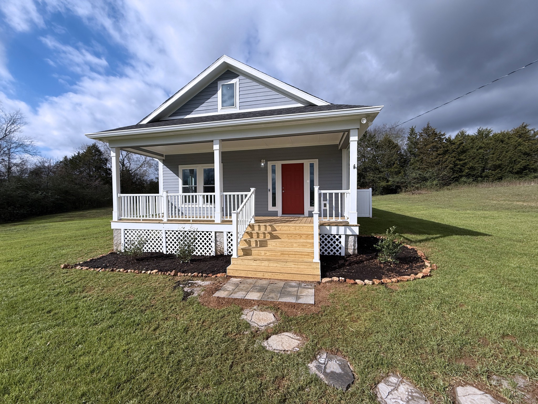 a front view of a house with a garden