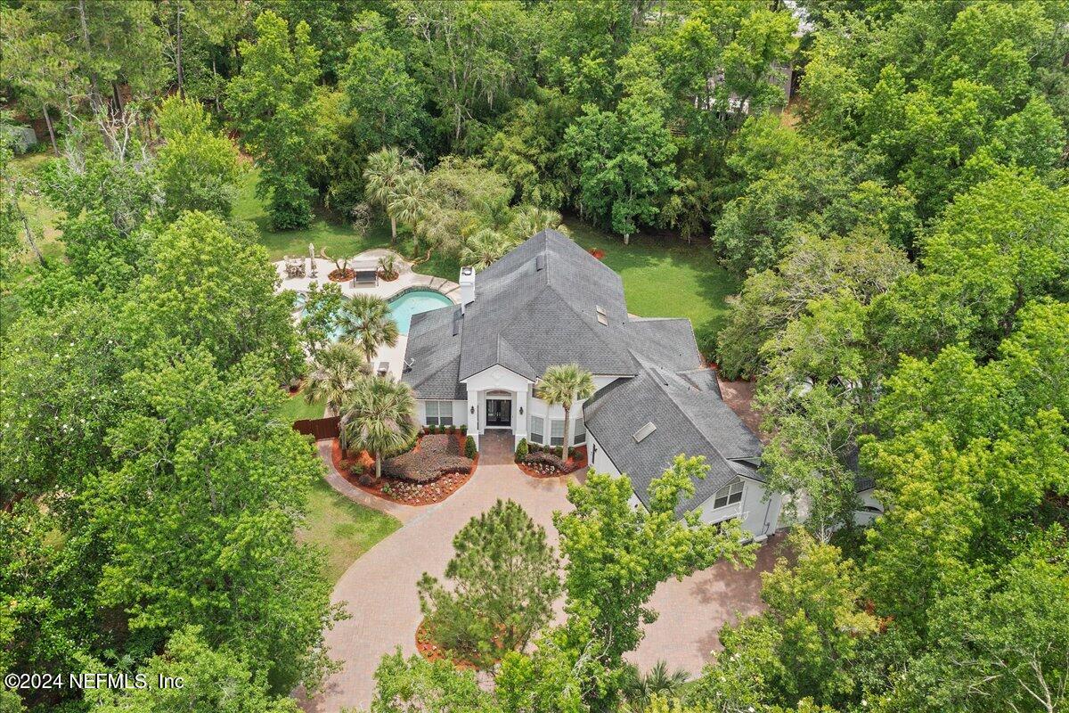 an aerial view of a house with garden space and sitting area