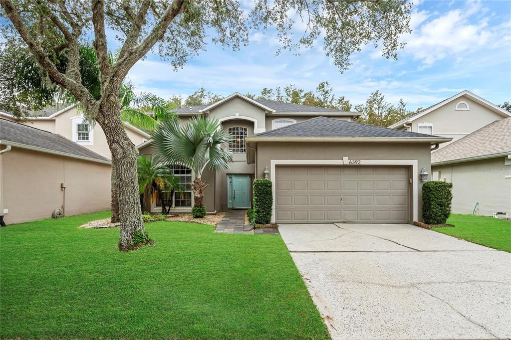 a front view of a house with a yard and garage