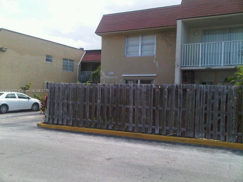 a view of a house with wooden fence