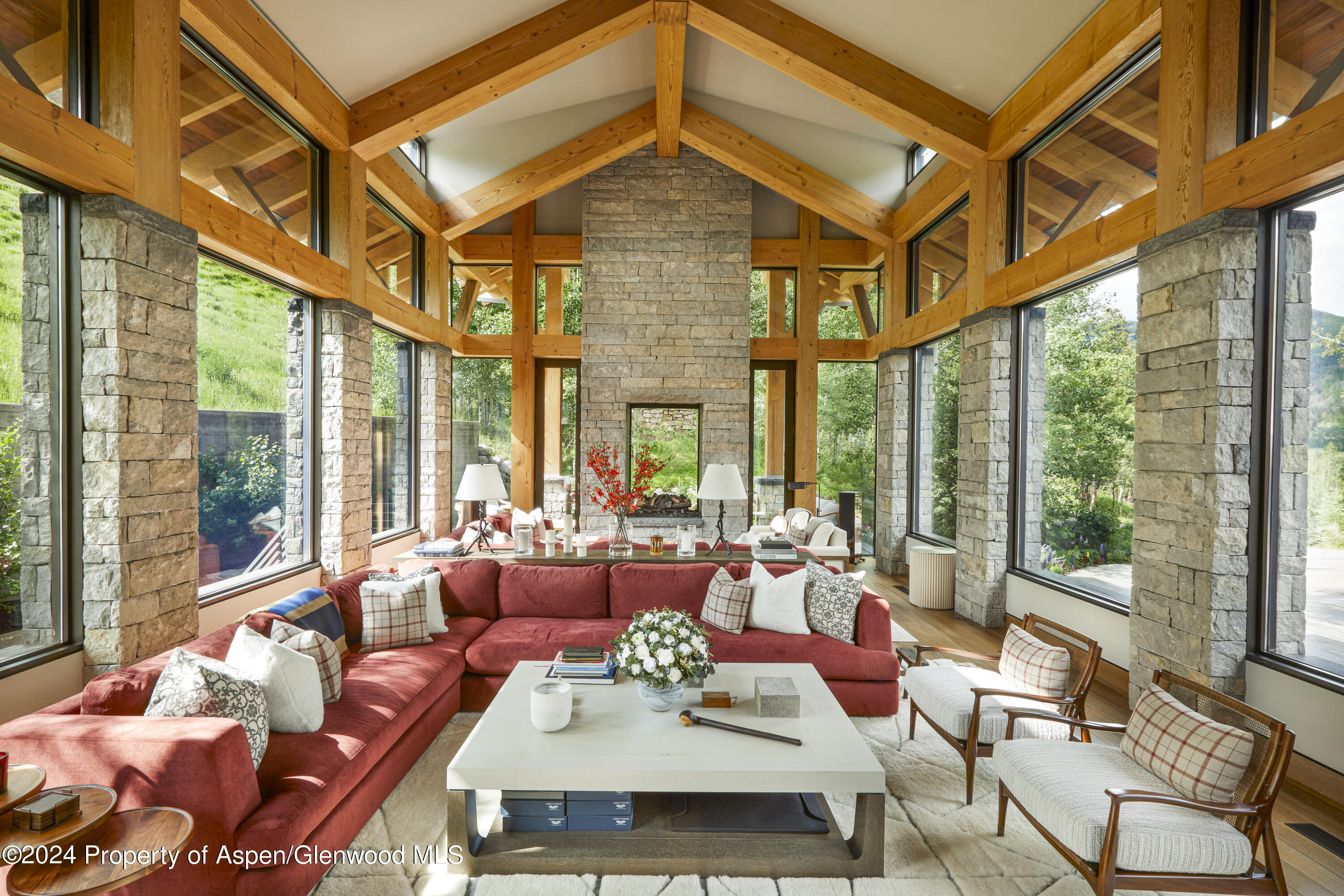 a living room with furniture a large window and dining table