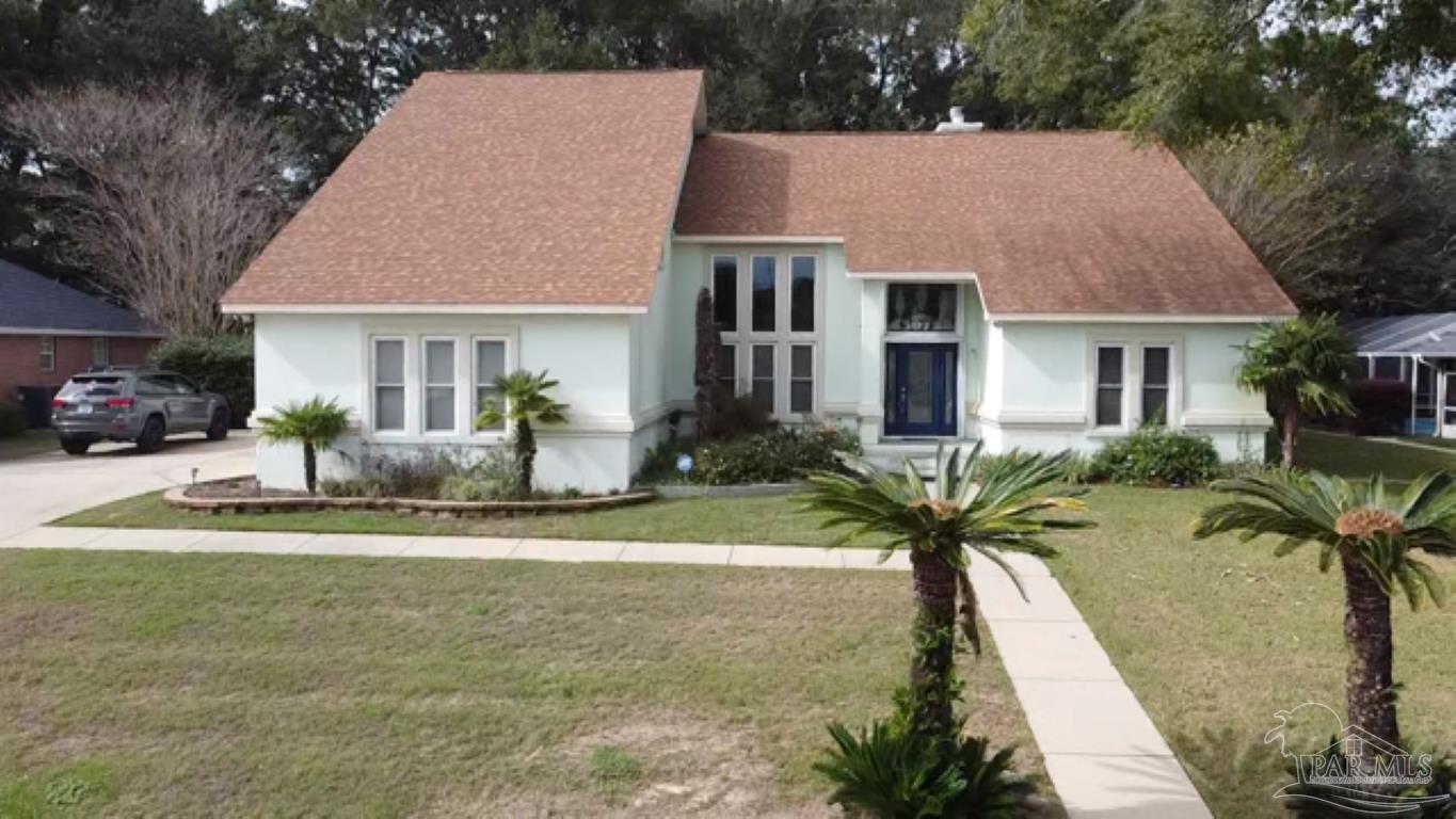 a front view of house with yard and green space