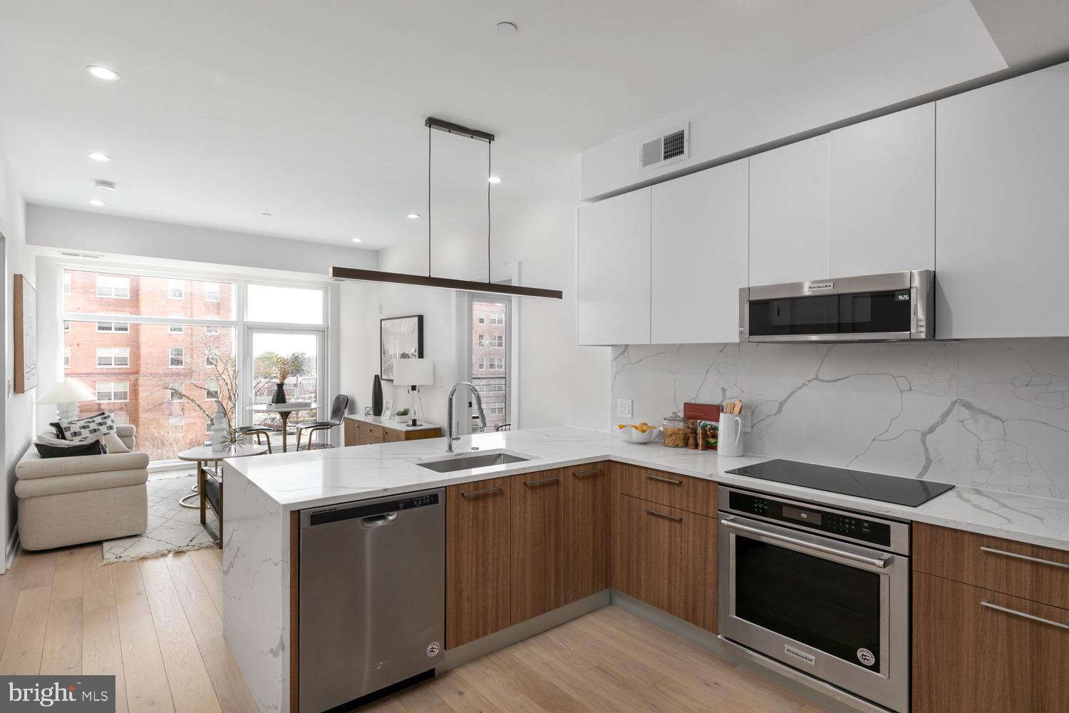 a kitchen with a sink stove and microwave