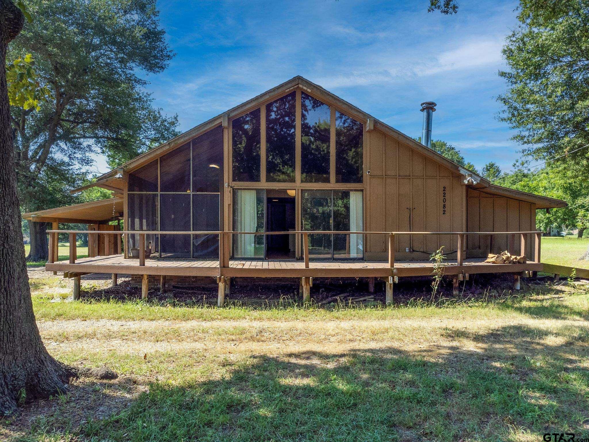 a view of a house with a yard and sitting area