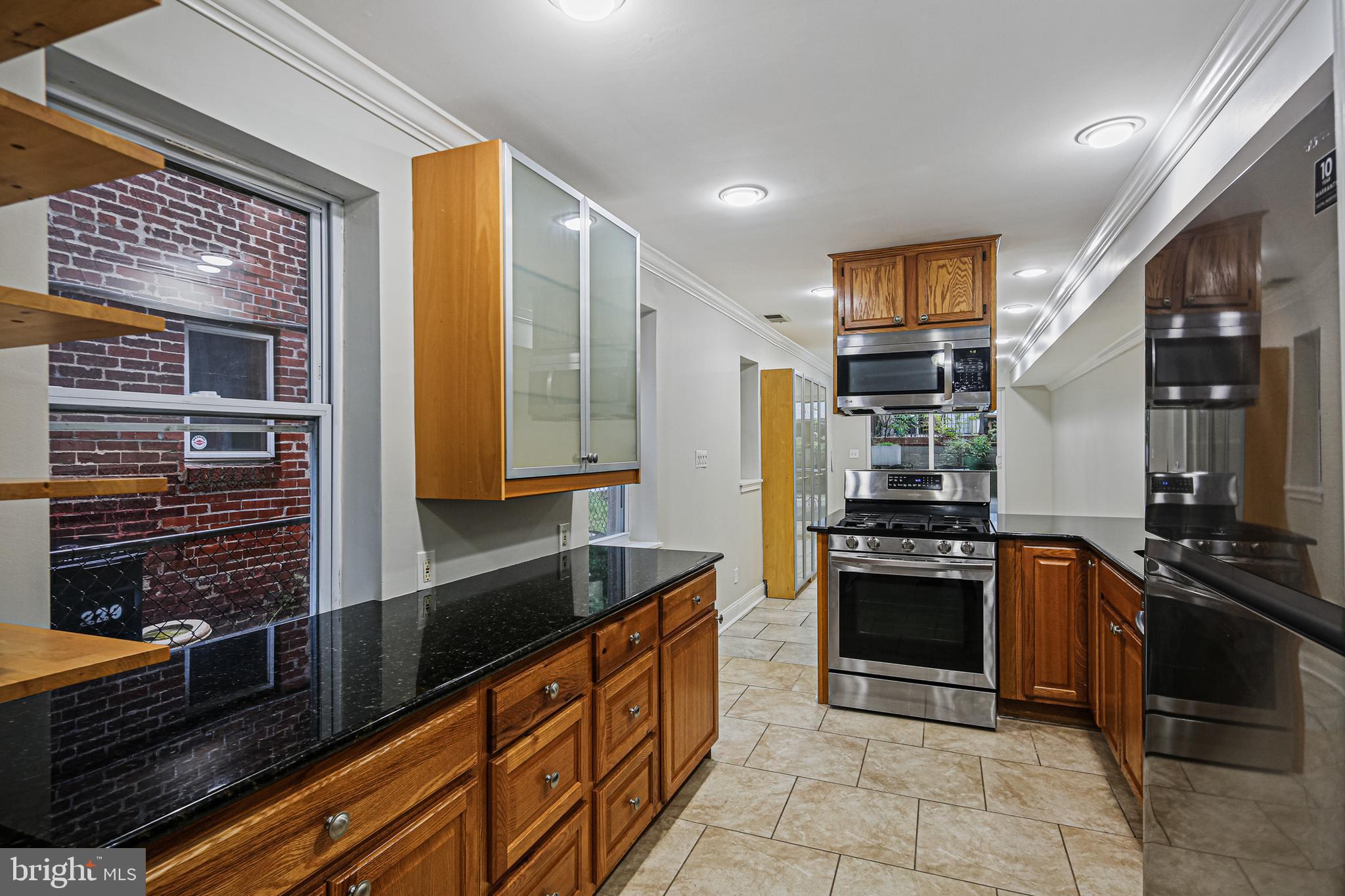 a kitchen with stainless steel appliances granite countertop a stove sink and cabinets