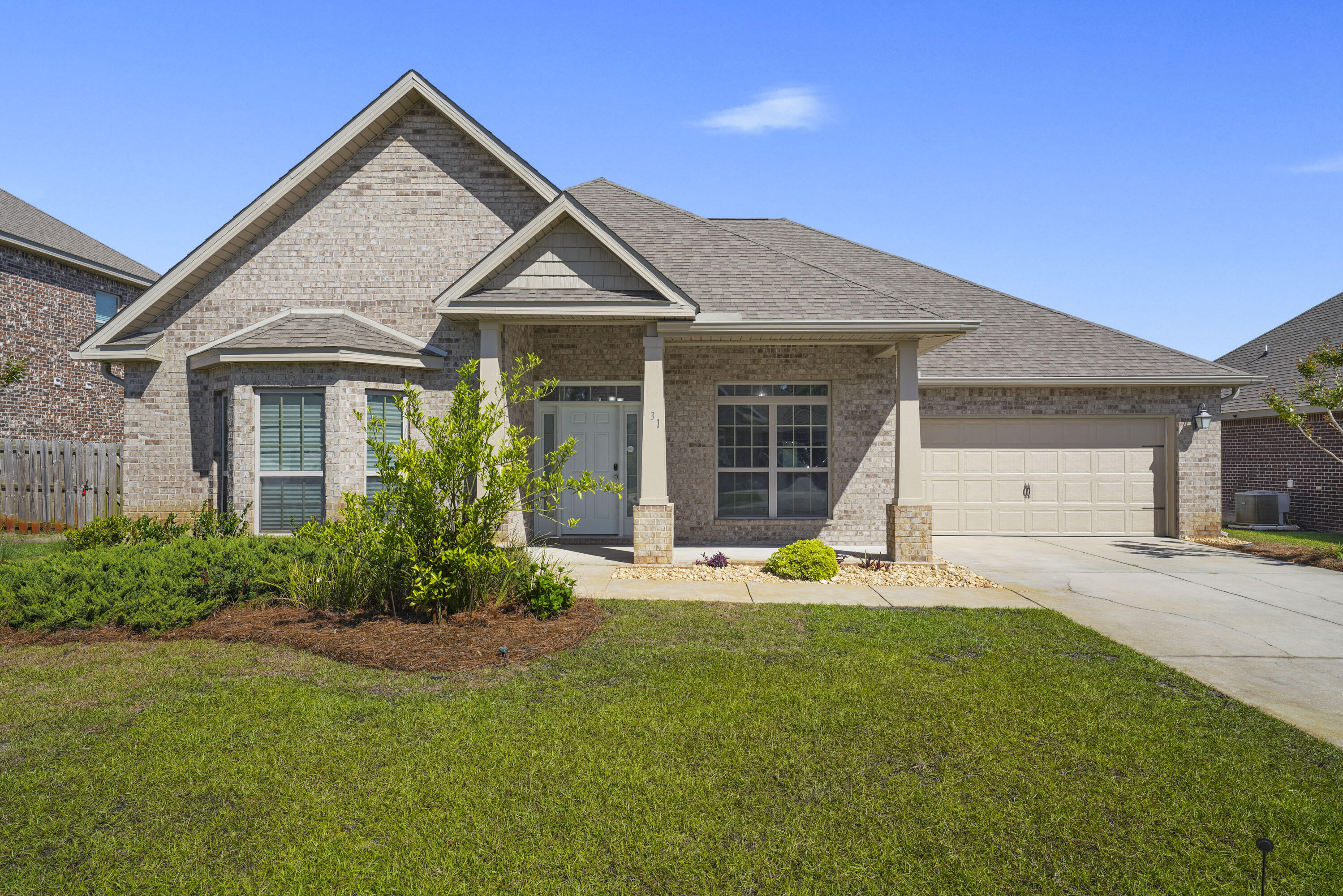 a view of a house with a yard and sitting area