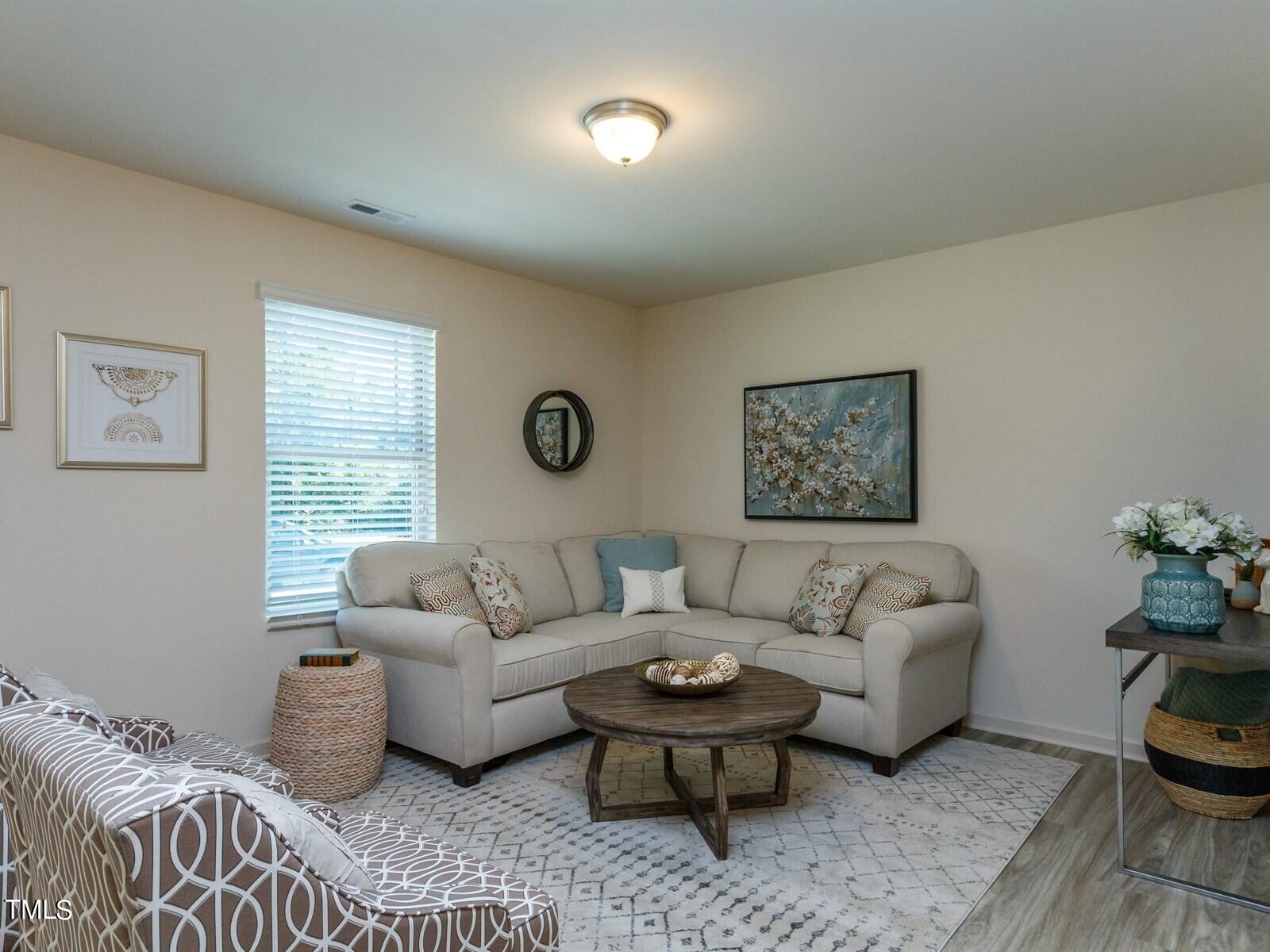 a living room with furniture and a window