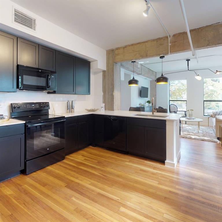 a kitchen with stainless steel appliances kitchen island granite countertop a sink counter space and cabinets