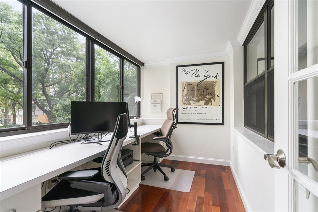 a view of workspace with wooden floor windows