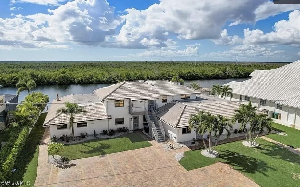 an aerial view of a house with a garden and plants