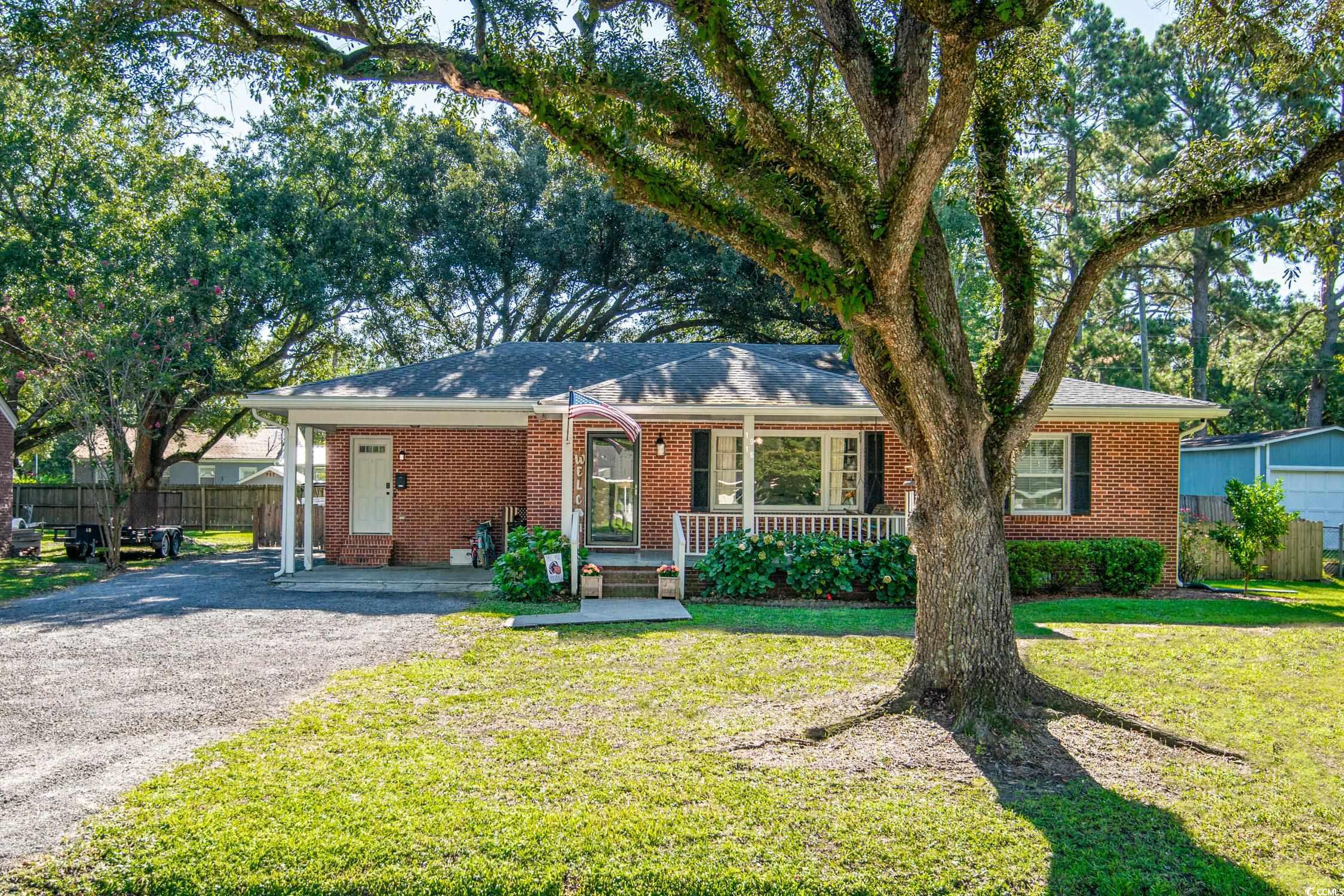 Ranch-style house with a porch and a front lawn