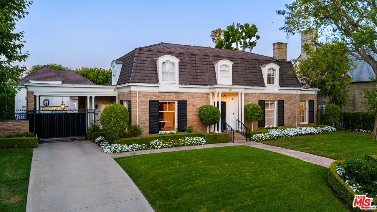 a front view of a house with a yard and porch