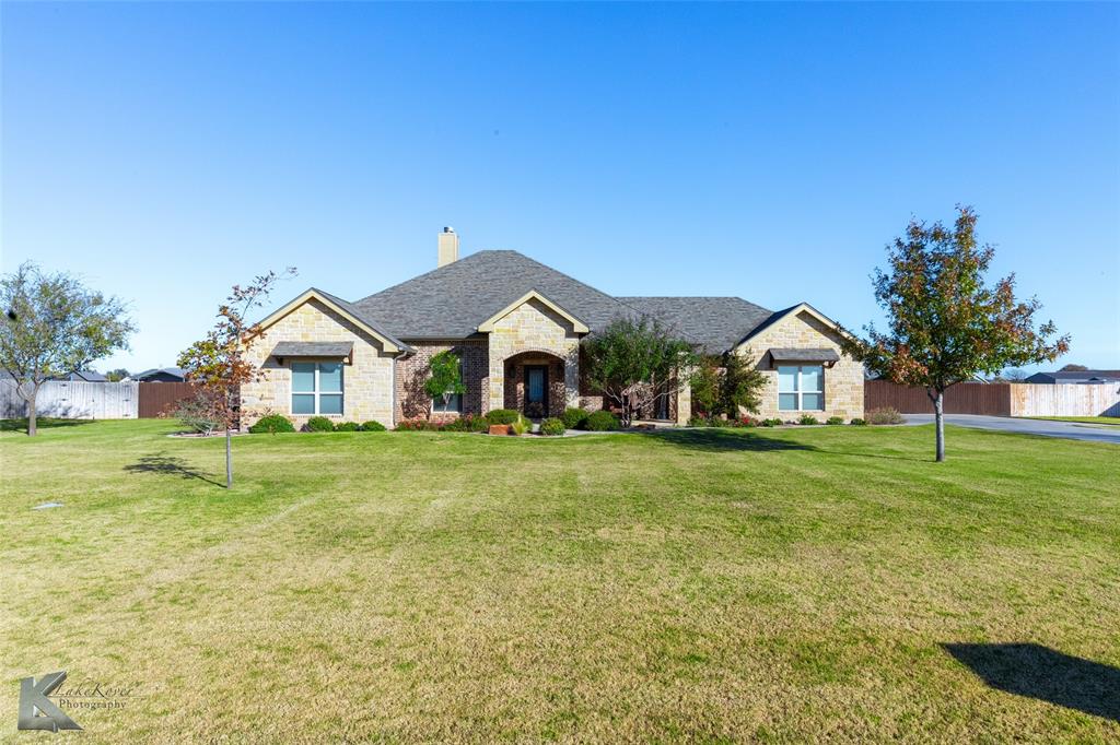 a front view of house with yard and green space