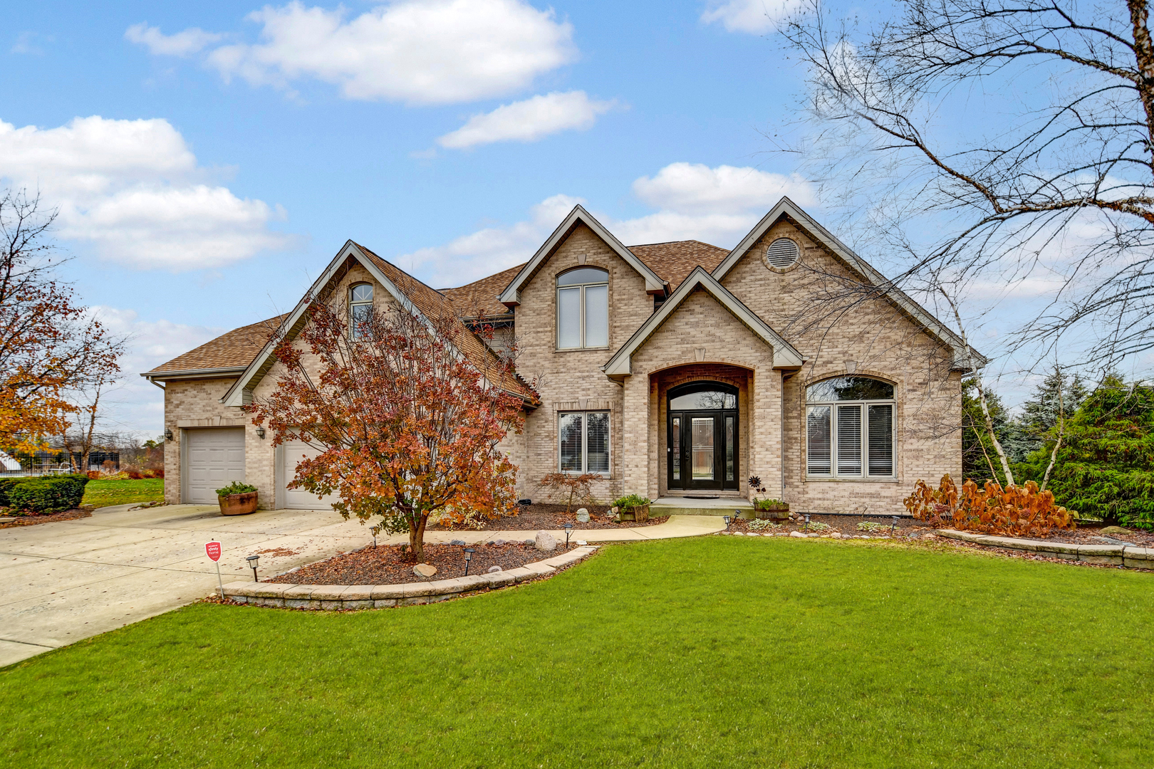 a front view of a house with a yard