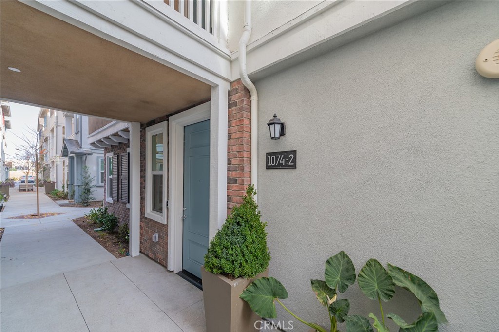 a house with potted plants in front of door