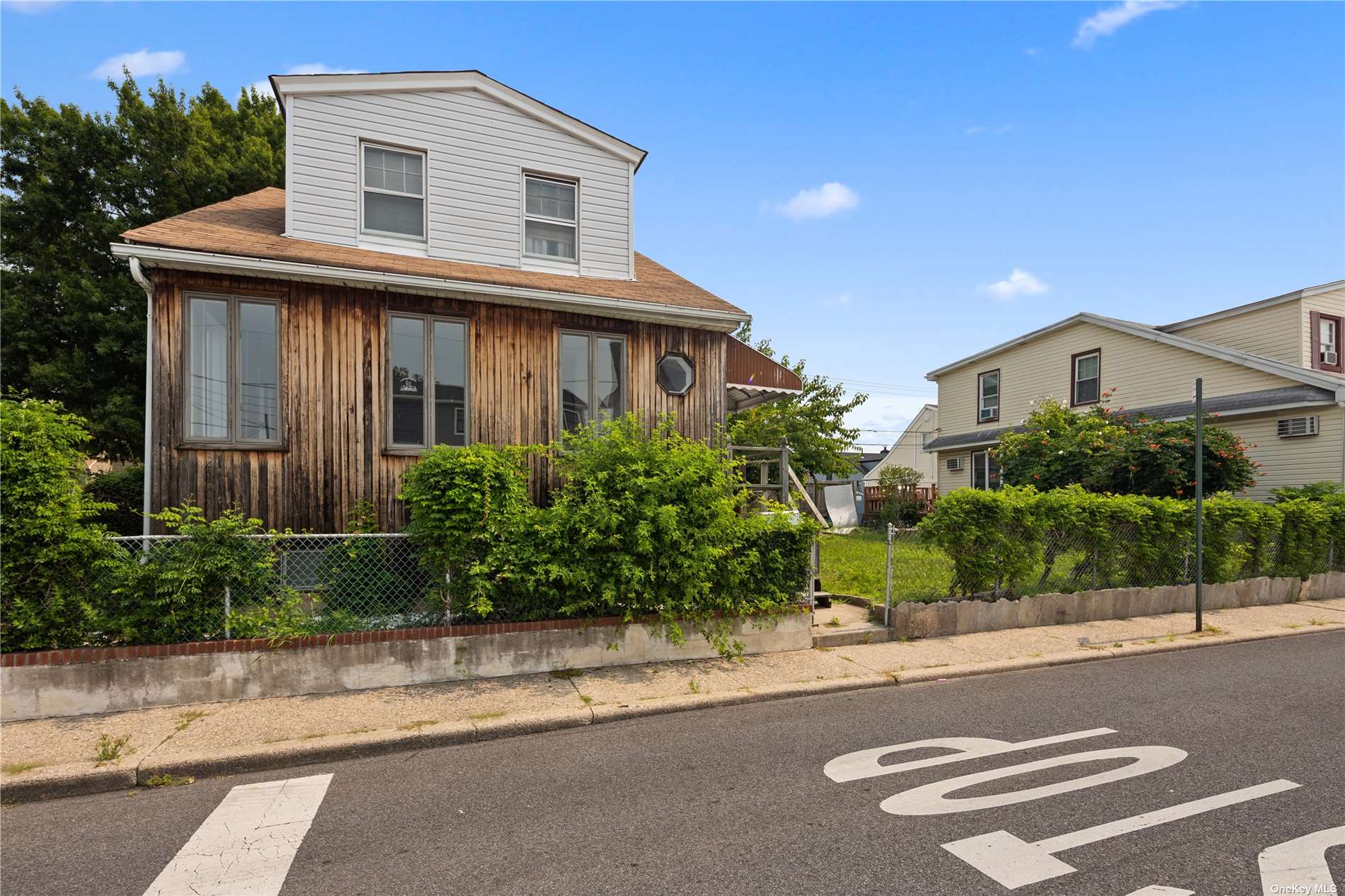 a front view of a house with a yard and a garage