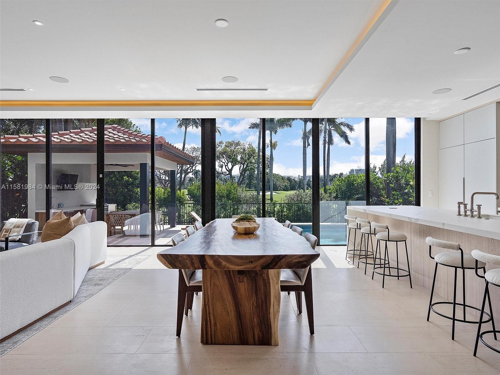 a dining room with furniture a large window and a table