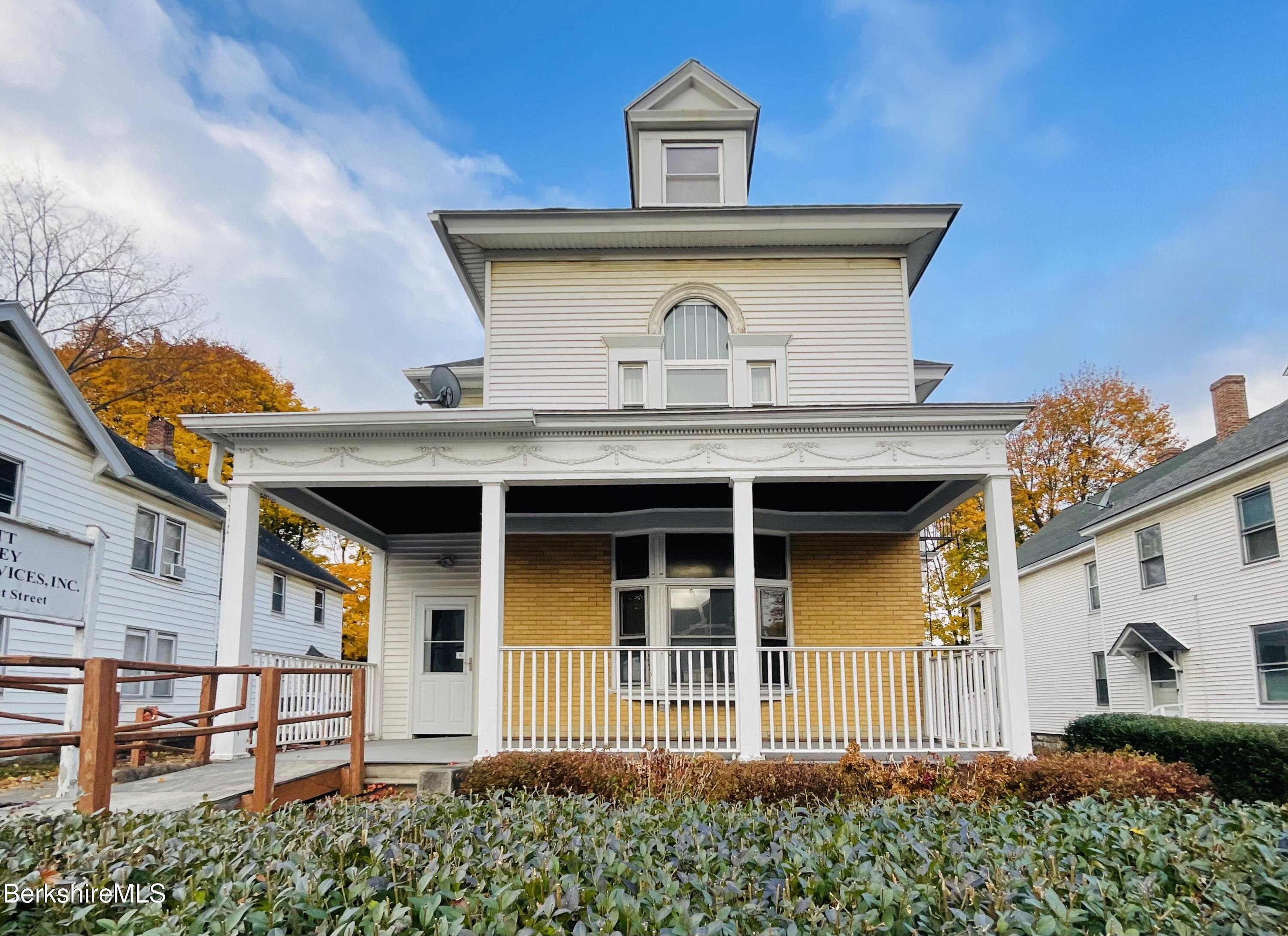 a front view of a house with a garden