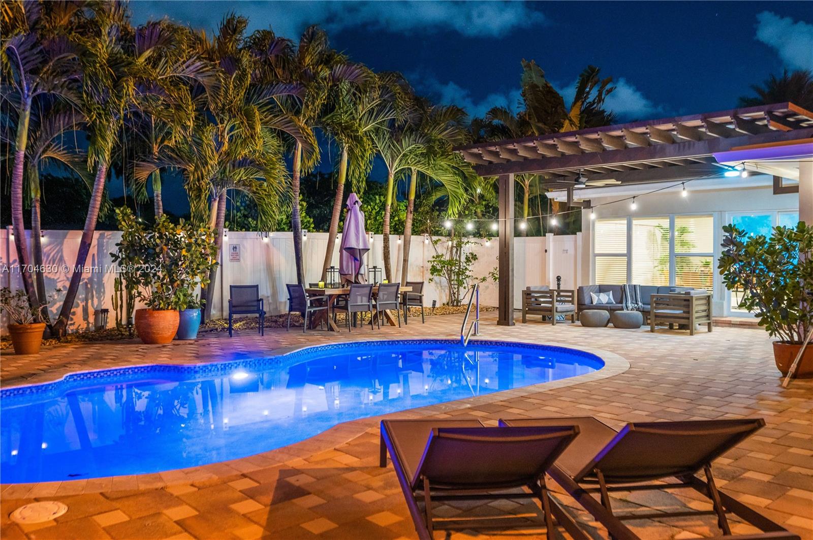 a view of a swimming pool with an outdoor seating