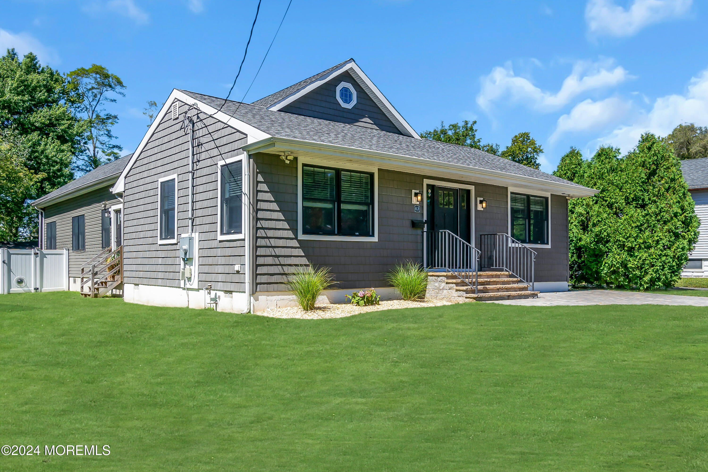 a front view of a house with a garden and porch