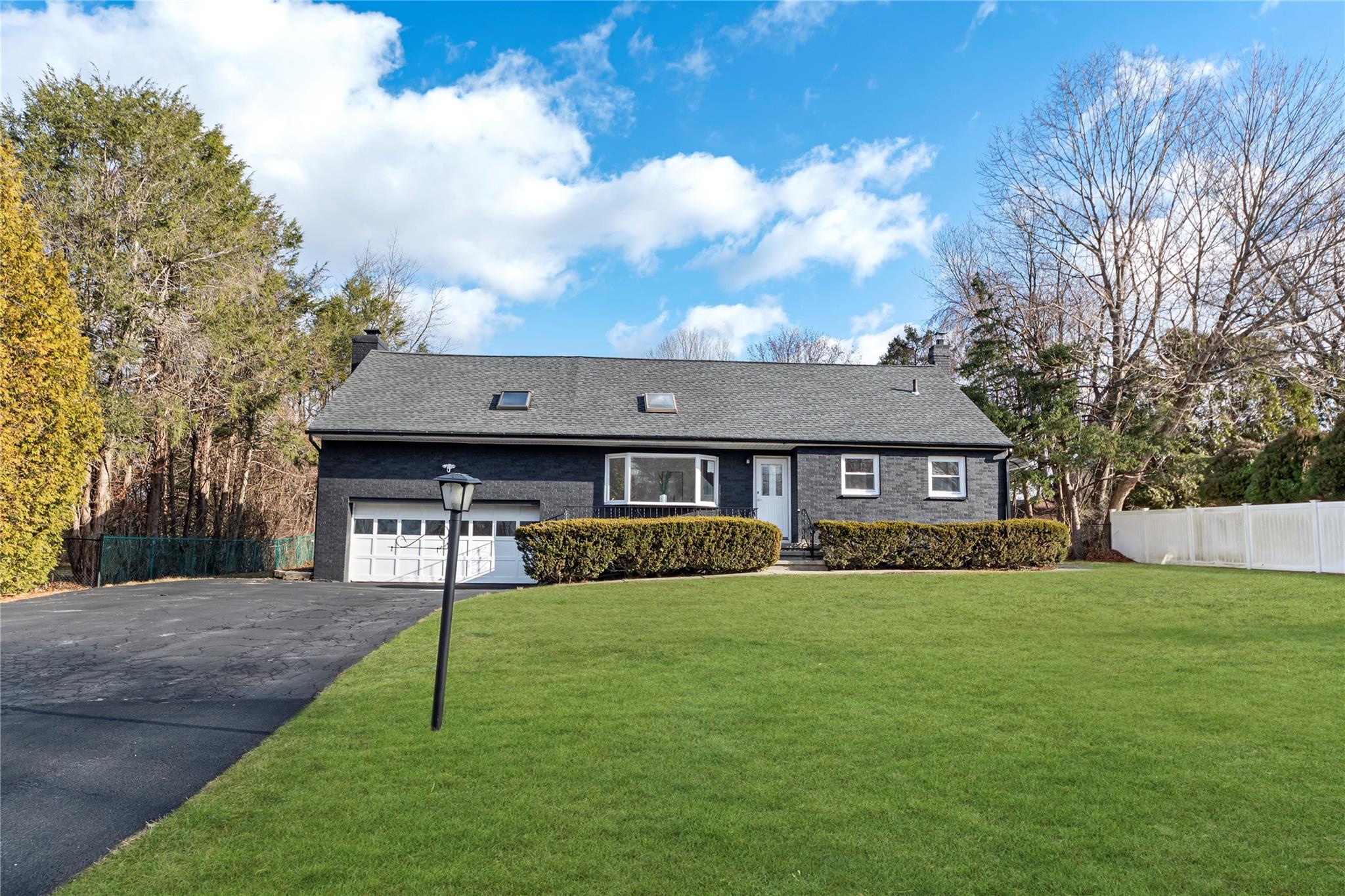 Ranch-style home with a front lawn