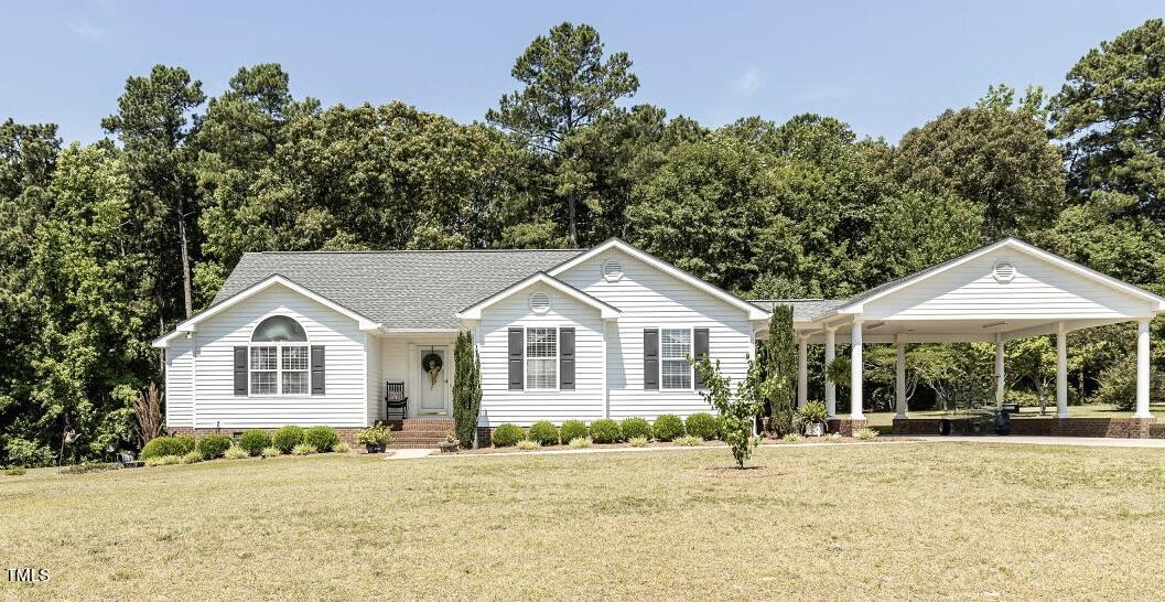 a front view of a house with a garden