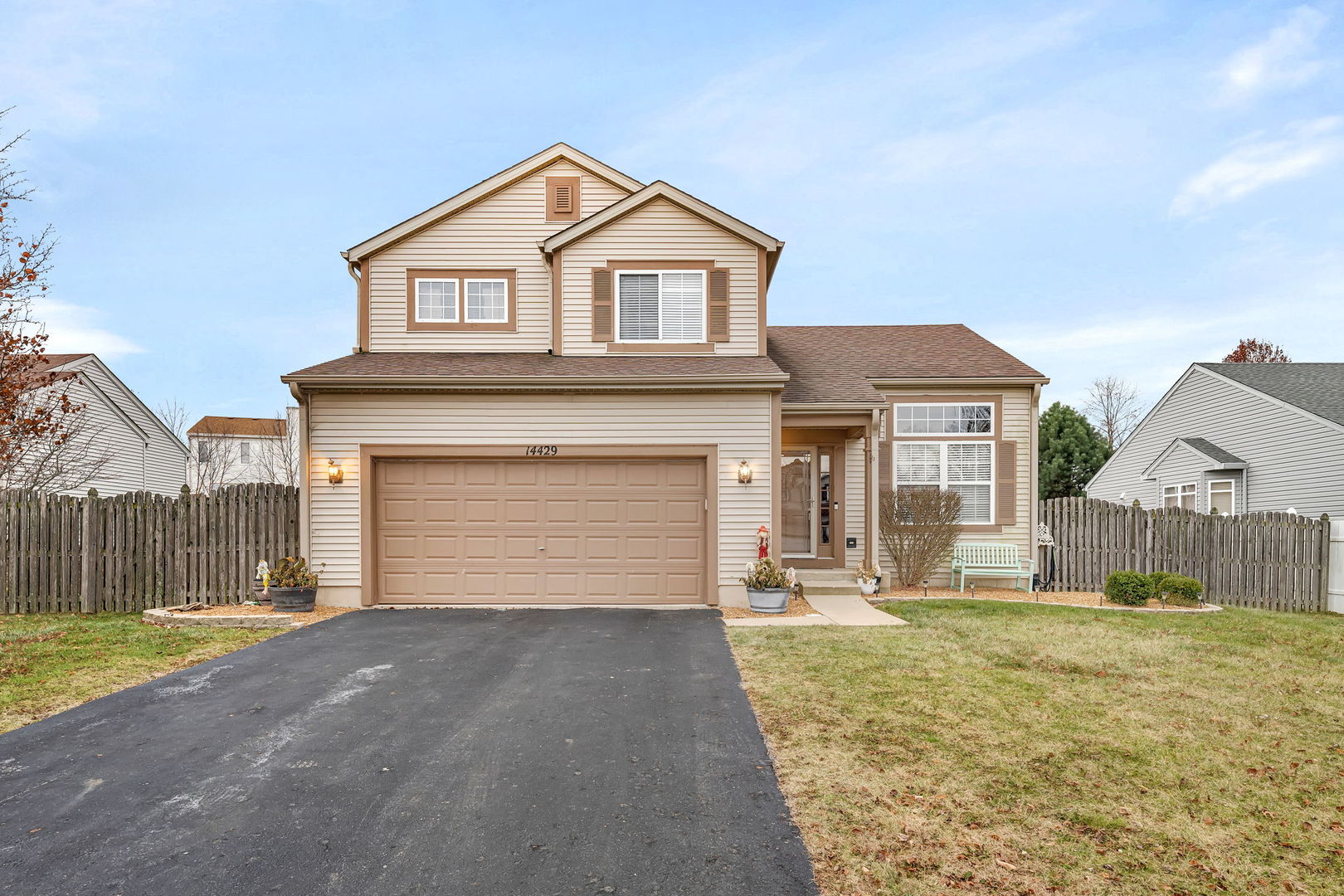 a front view of a house with a yard and garage