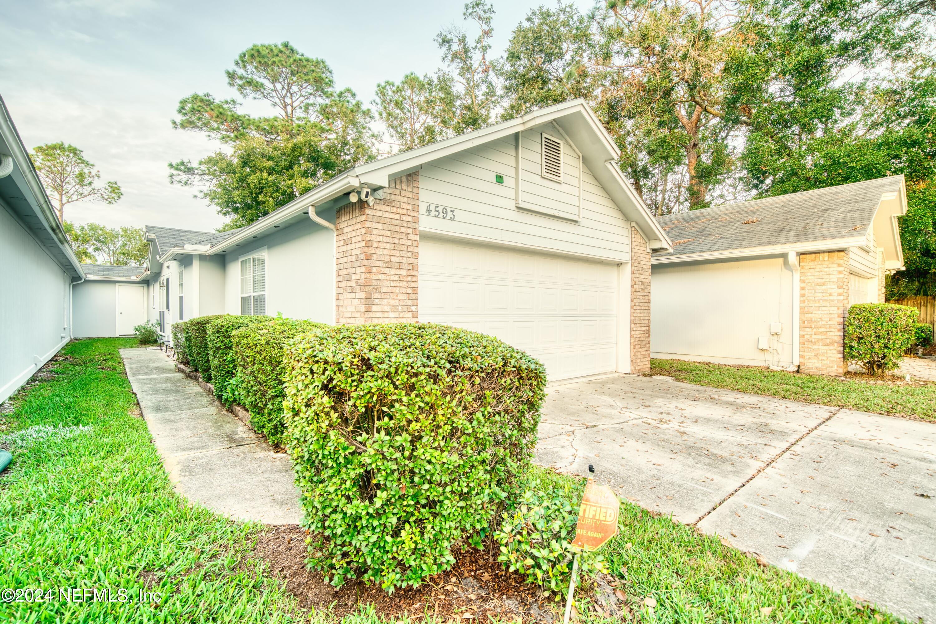 a view of a yard in front of a house with plants