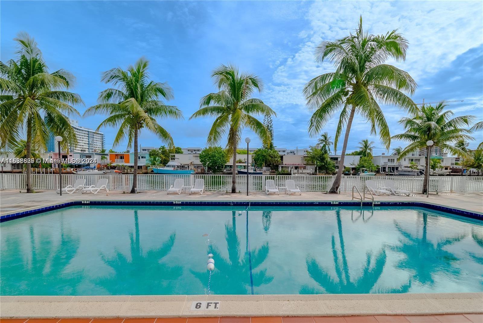 a view of swimming pool with outdoor seating