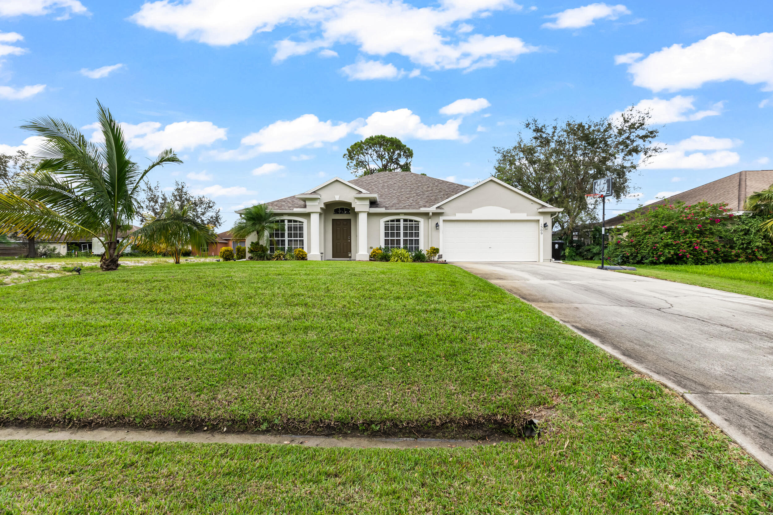 a front view of a house with a garden