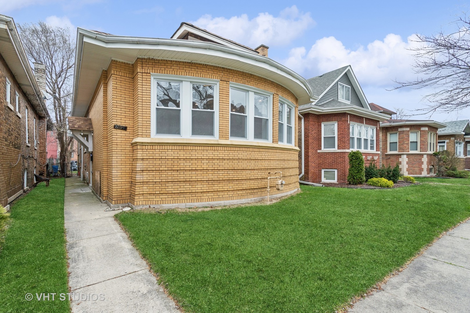 a front view of a house with a garden