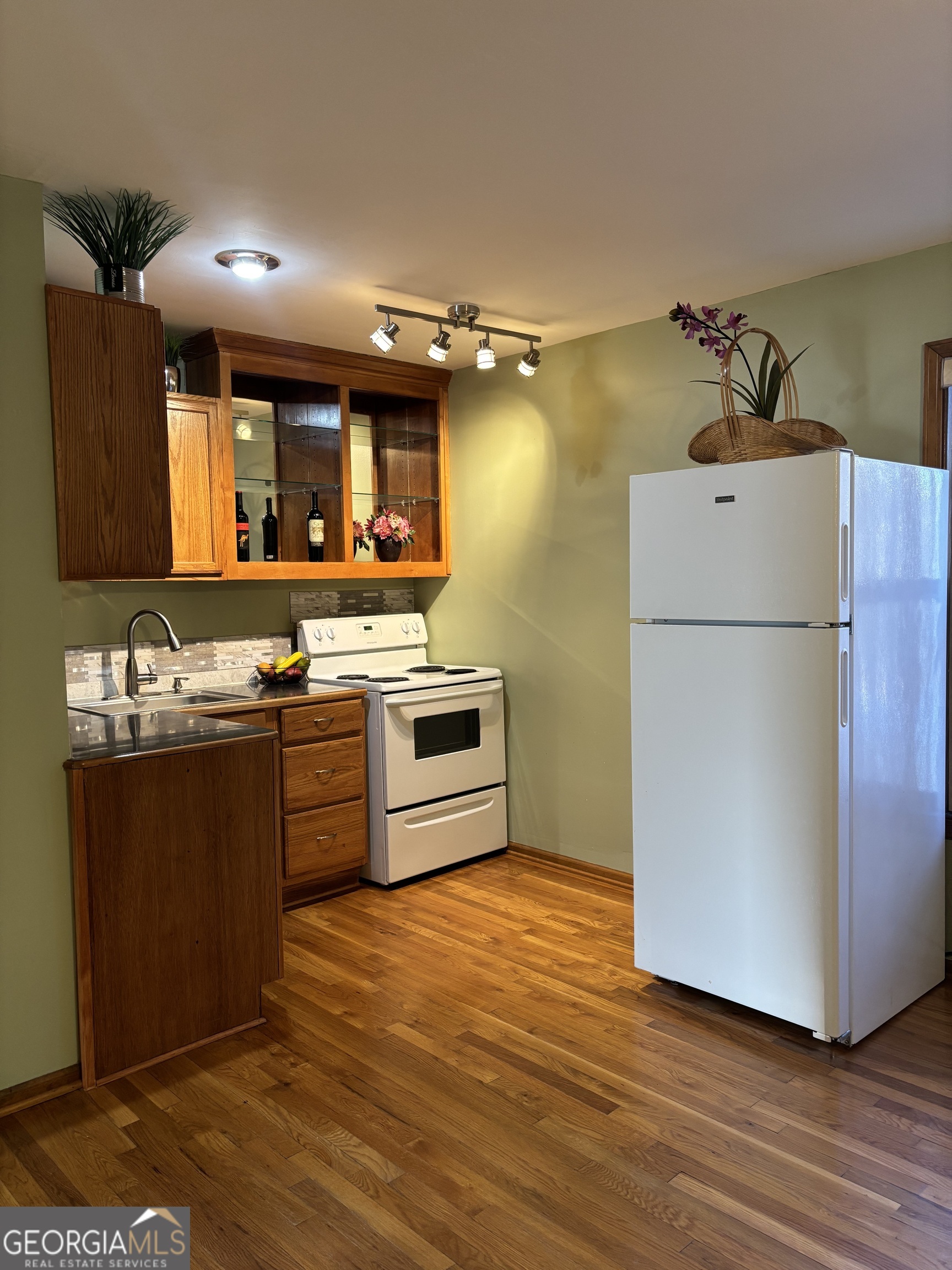 a kitchen with granite countertop a refrigerator and a stove