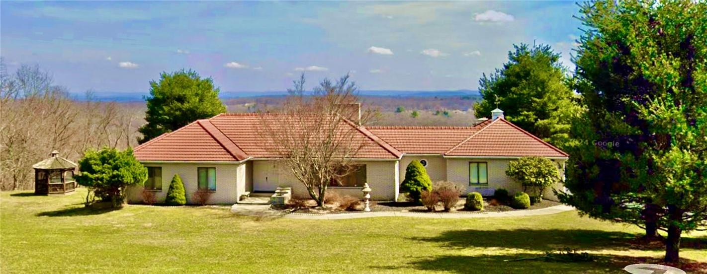 a view of a house with swimming pool and sitting area