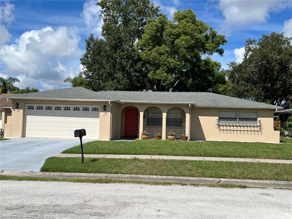 a view of a house with a yard and garage