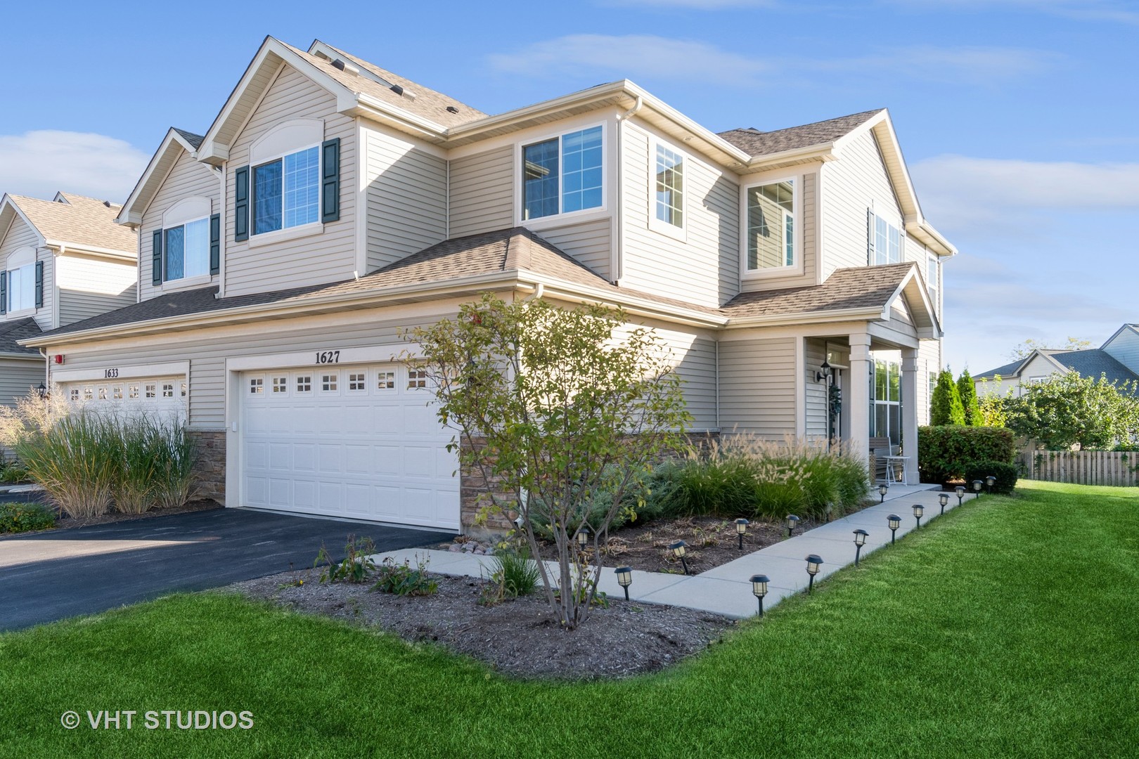 a front view of a house with a yard and outdoor seating