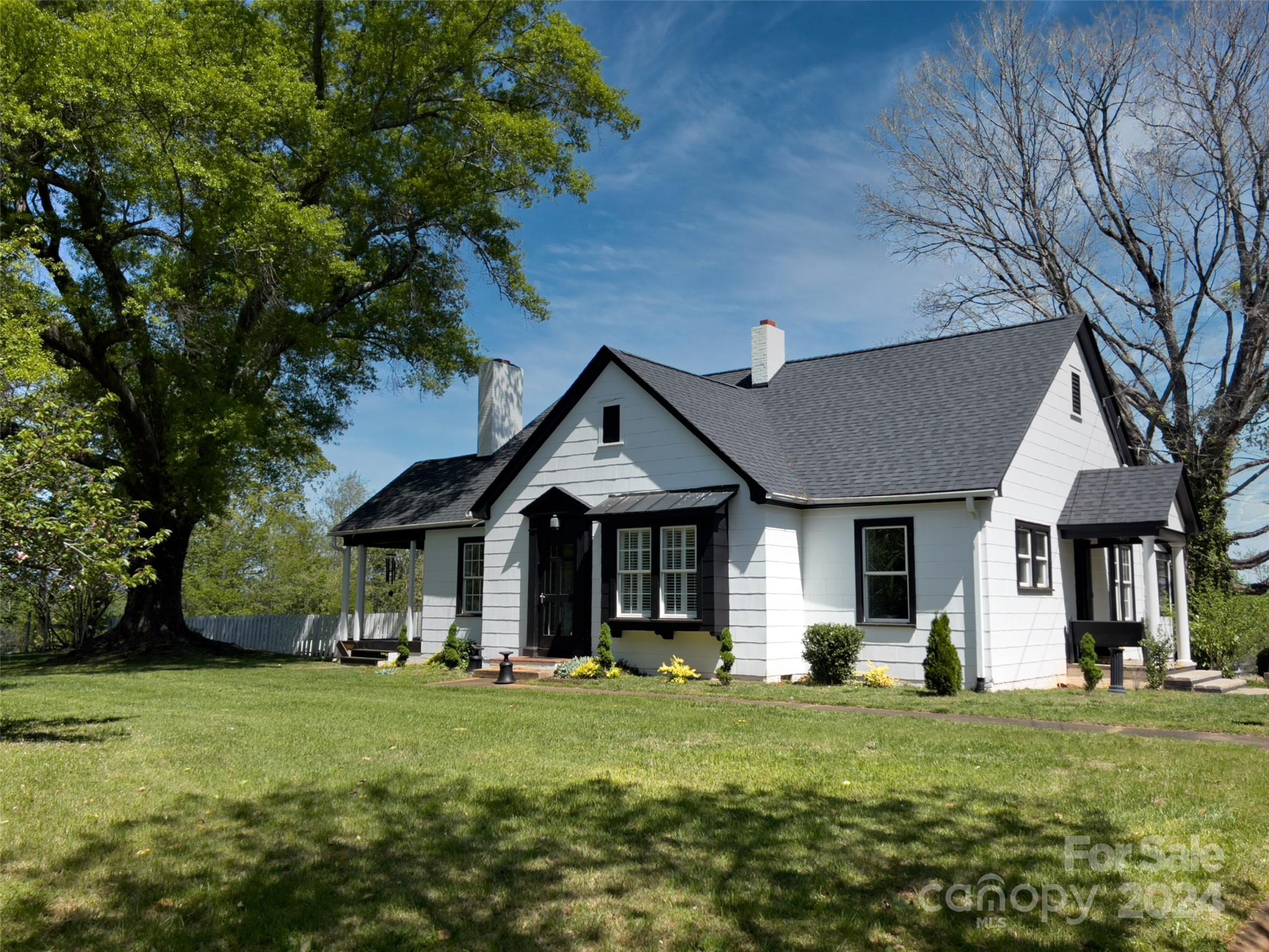 a front view of a house with a yard and porch