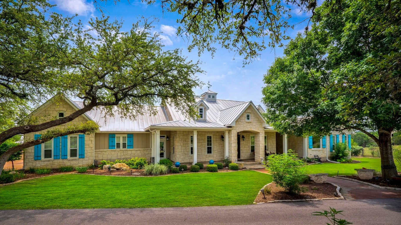 a front view of a house with a garden and plants