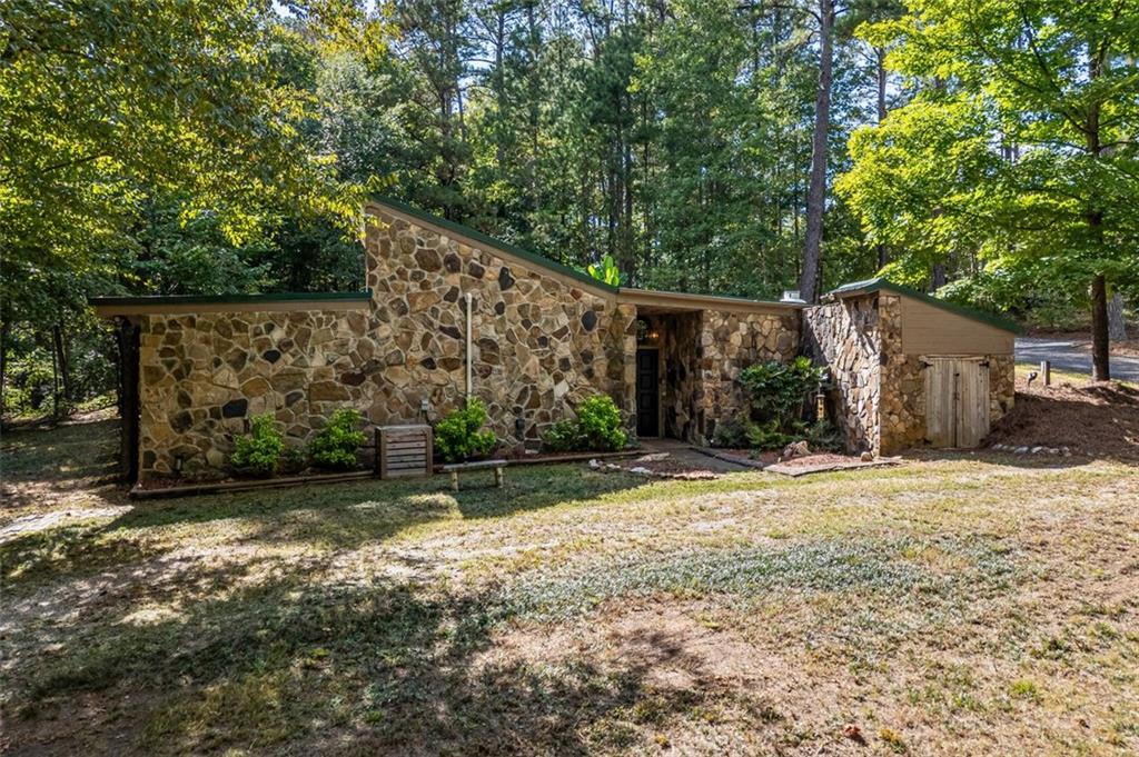 a view of a house with a yard and tree