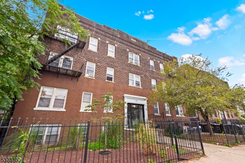 a view of a brick building next to a yard